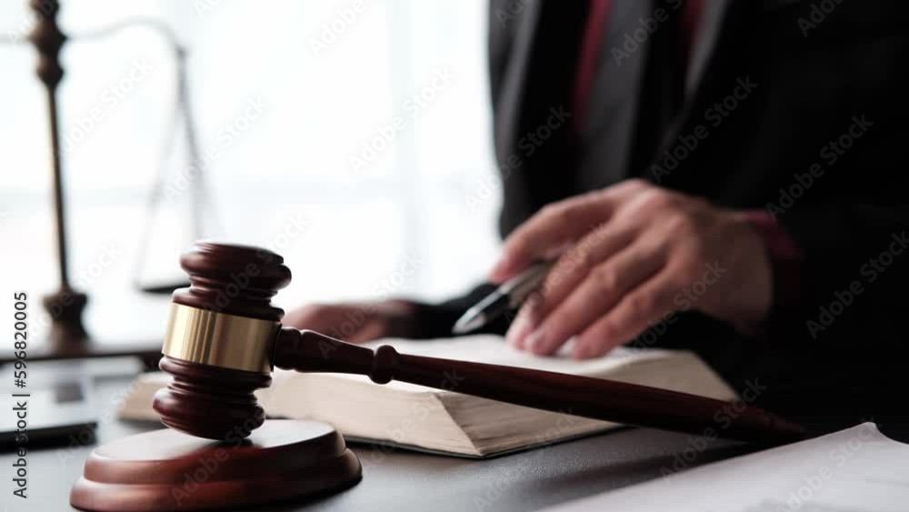 justice and law concept.Male judge in a courtroom on wooden table and Counselor or Male lawyer working in office. Legal law, advice and justice concept. justice and law concept.Male judge in a courtroom on wooden table and Counselor or Male lawyer working in office. Legal law, advice and justice concept.