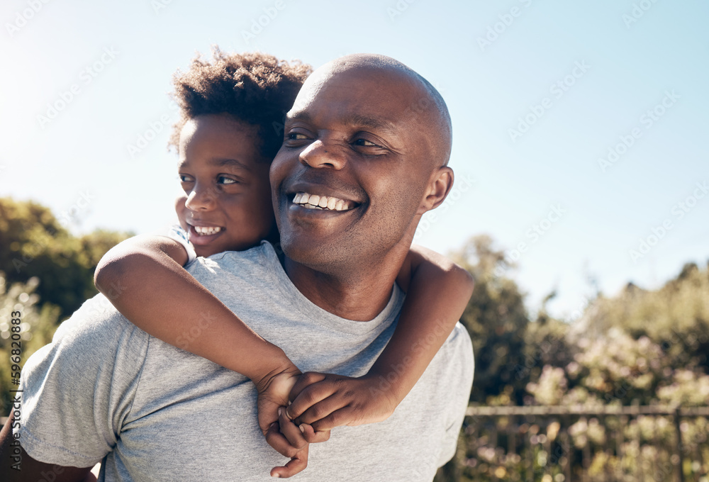 Fototapeta premium Closeup of a happy african american man bonding with his young little boy outside. Two black male father and son looking happy and positive while being affectionate and walking in a park