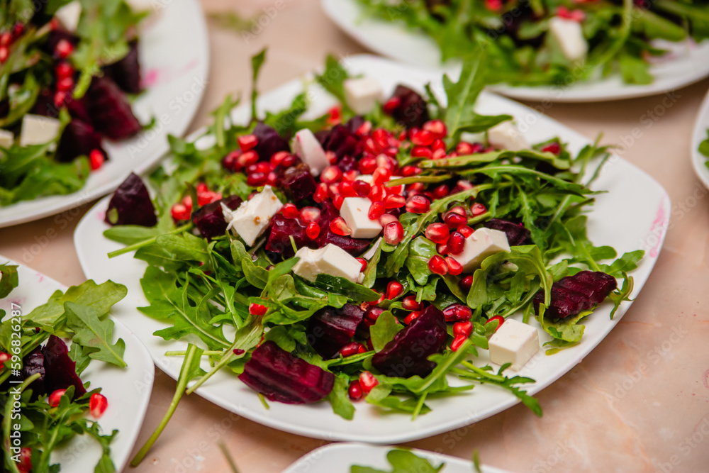 Salad with beetroot from arugula with cheese and pomegranate. Vegetarian food. Salad with beetroot from arugula with cheese and pomegranate. Vegetarian food.