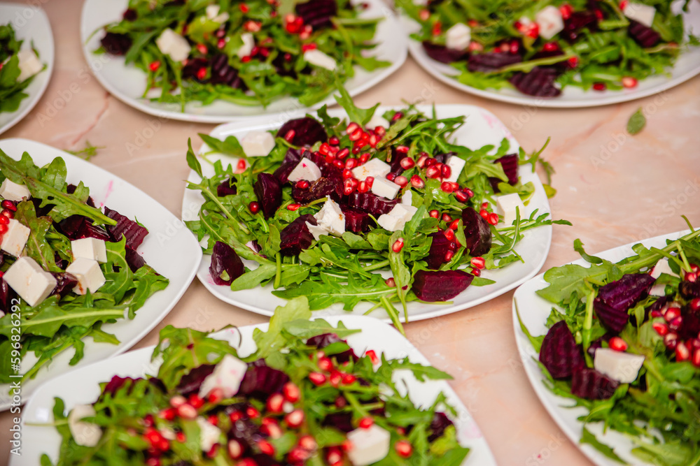 Salad with beetroot from arugula with cheese and pomegranate. Vegetarian food. Salad with beetroot from arugula with cheese and pomegranate. Vegetarian food.
