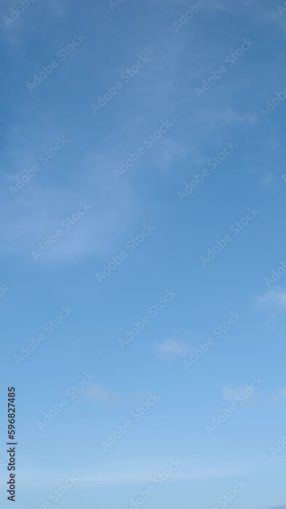 Rare clouds move calmly in a clear blue sky, time-lapse video, sky background. Vertical video. Rare clouds move calmly in a clear blue sky, time-lapse video, sky background. Vertical video.