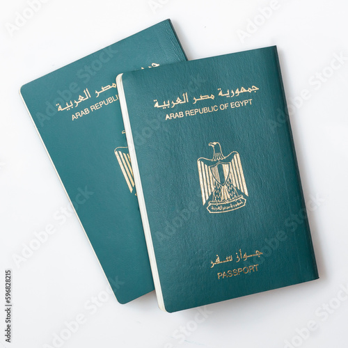 Two Egyptian Passports, Isolated on White Background, Arabic Text "Arab Republic of Egypt Passport", Top View