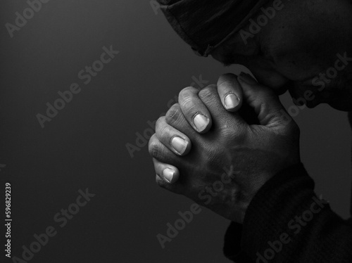 man praying to god with hands together Caribbean man praying with black background stock photos stock photo  © herlanzer