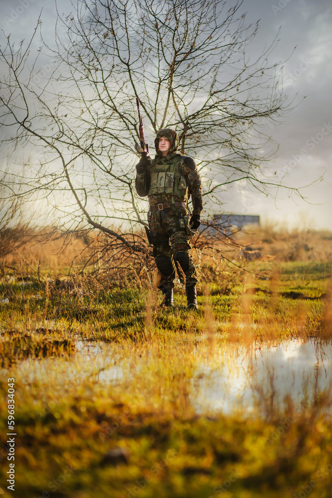 airsoft. a woman in camouflage with machine guns in her hands on the ruins. airsoft. a woman in camouflage with machine guns in her hands on the ruins.