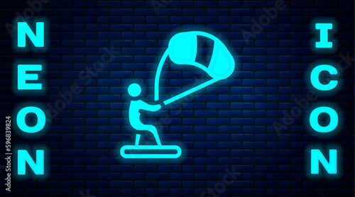 Glowing neon Kitesurfing icon isolated on brick wall background. Vector
