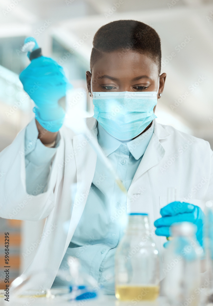 Getting down to the root of the problem. Shot of a young scientist sitting alone in her laboratory and testing urine. Getting down to the root of the problem. Shot of a young scientist sitting alone in her laboratory and testing urine.
