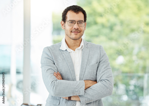 Free Download I always do business with confidence. Portrait of a confident young businessman standing with his arms crossed in an office. - GFXLoad