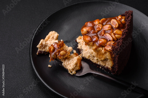 Delicious fresh cheesecake cake or snickers with cream and nuts