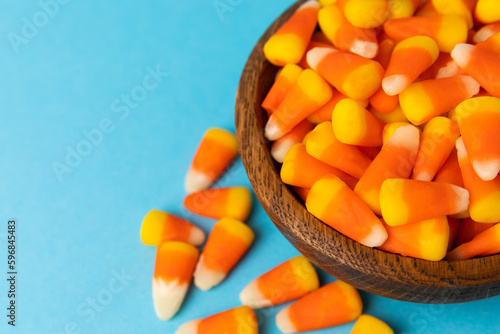 Halloween candy on a bright blue background. corn and pumpkin coffees, marmalade.Halloween holiday background with jack o lantern pumpkin, candy corn and decorations.Top view.Flat lay. Place for text.