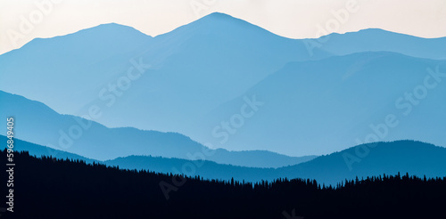 Layered mountain panoramic in blue monochromatic tones 