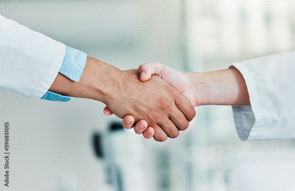 Lets advance together. Closeups shot of two unrecognisable scientists shaking hands in a lab. Lets advance together. Closeups shot of two unrecognisable scientists shaking hands in a lab.