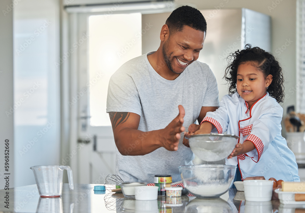 Baking is an opportunity to share quality time with a loved one. Shot of a father baking with his daughter at home. Baking is an opportunity to share quality time with a loved one. Shot of a father baking with his daughter at home.