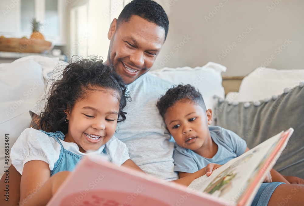 Everyone gets a turn to read. Shot of a young man reading to his kids on the sofa at home. Everyone gets a turn to read. Shot of a young man reading to his kids on the sofa at home.