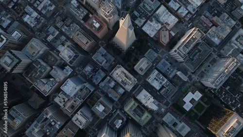 Top down panning footage of town development. Fly above Transamerica Pyramid and surrounding streets and buildings.