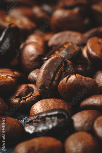 close up view of brown coffee seeds on dark surface textured grain © Kamran