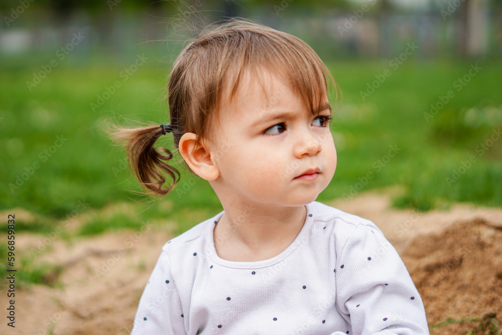 Little girl portrait - Pigtail little girl close up - Kid in nature focusing face Little girl portrait - Pigtail little girl close up - Kid in nature focusing face