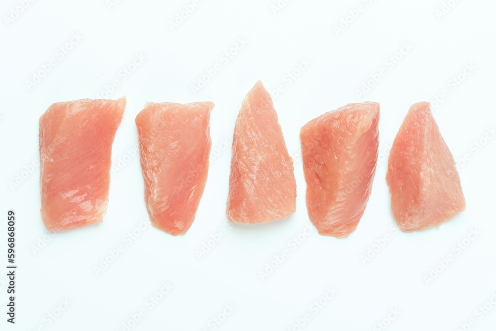 Raw chicken.Frozen chicken fillet..Ogranic food and healthy eating.frozen turkey or poultry meat.Fresh frozen pieces of turkey meat on a white background.