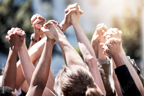 Uniting for a cause. Shot of a group of protestors with their fists raised.