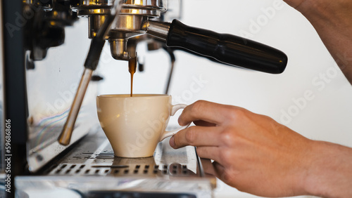 Close up of barista making coffee in cafe. Preparation service concept