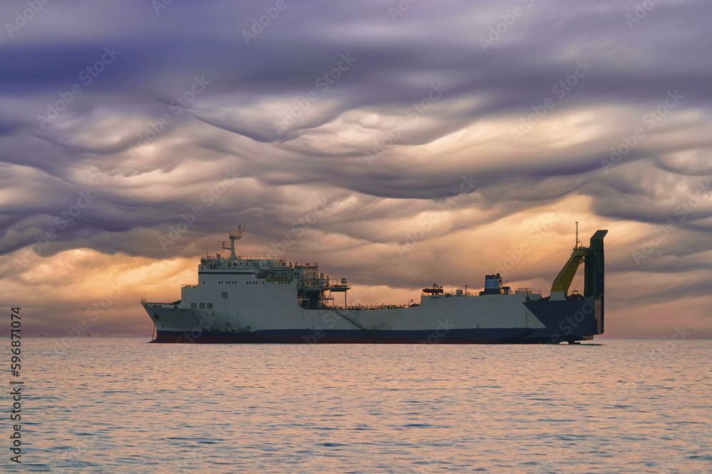 cargo ship at sunset, gorgeous clouds and cargo ship cargo ship at sunset, gorgeous clouds and cargo ship