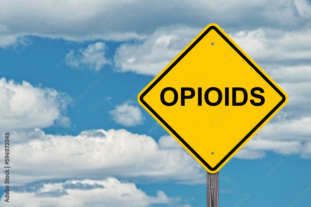 Opioids Ahead Caution Sign - Blue Sky Background Opioids Ahead Caution Sign - Blue Sky Background