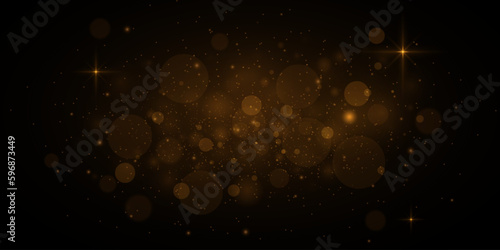 Glowing golden bokeh circles, sparkling gold dust. Abstract gold luxury light decoration.