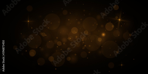 Glowing golden bokeh circles, sparkling gold dust. Abstract gold luxury light decoration.