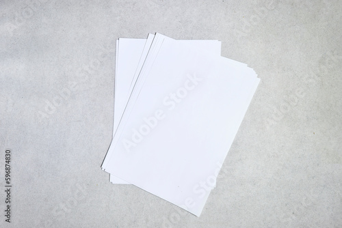 Blank paper sheets for brochure on grey background, top view. Mock up © hadjanebia