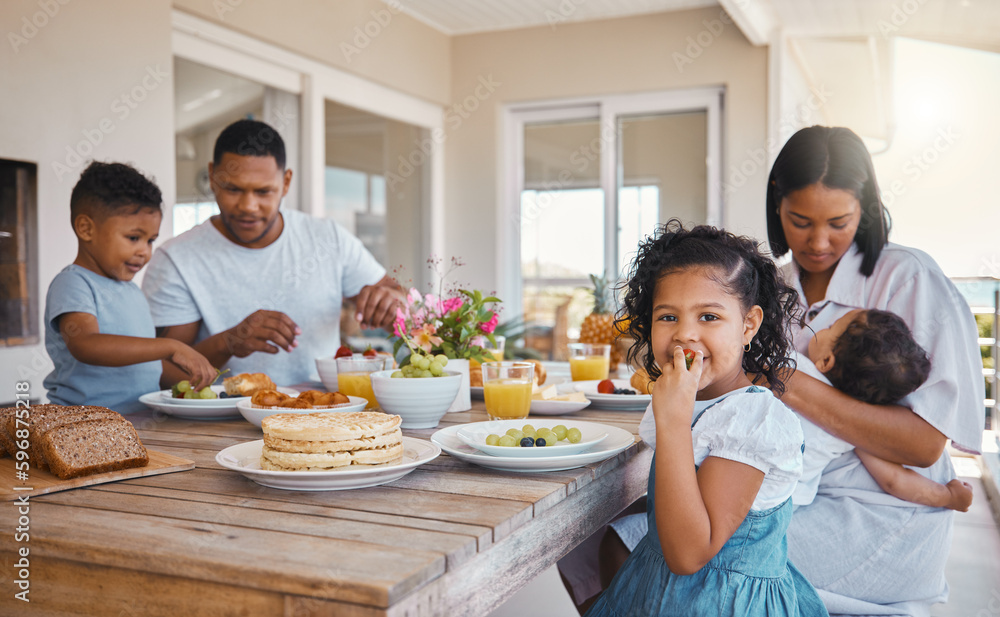Happy, healthy girl. Shot of a young family having lunch together at home.