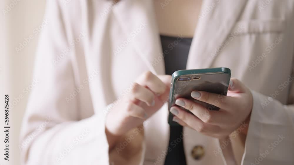 Close-up of a person's hands holding and using a smartphone, possibly texting or browsing.
Close-up of a person's hands holding and using a smartphone, possibly texting or browsing.