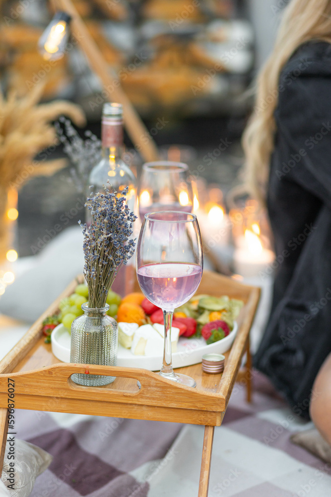 Romantic picnic with wine, cheese, lavender, strawberry