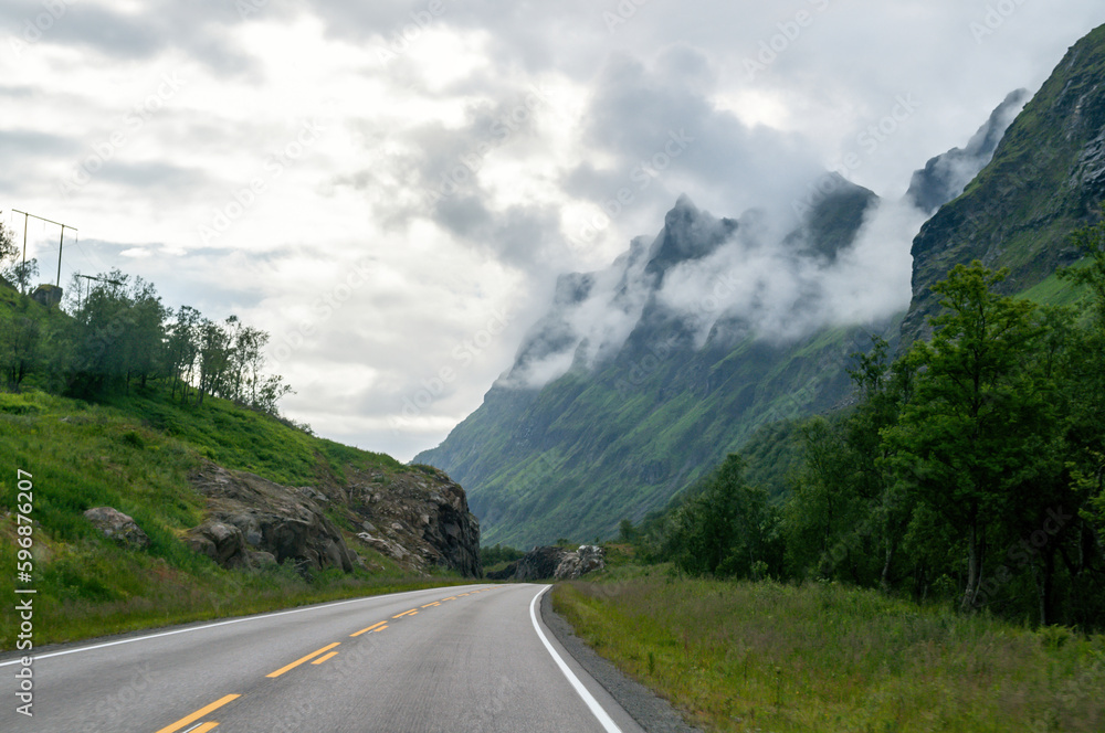 Empty road in the cloudy mountains in the north of Europe in Norway