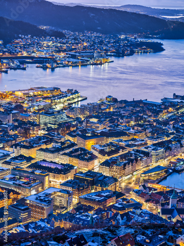 Bergen city lit up in golden lights in the evening, Norway