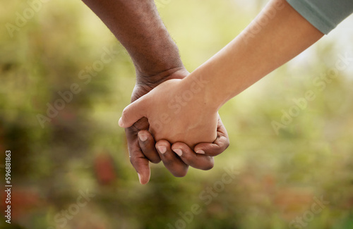 Konstfotografi Closeup of biracial couple interlocking their fingers and holding hands while bonding in the garden at home