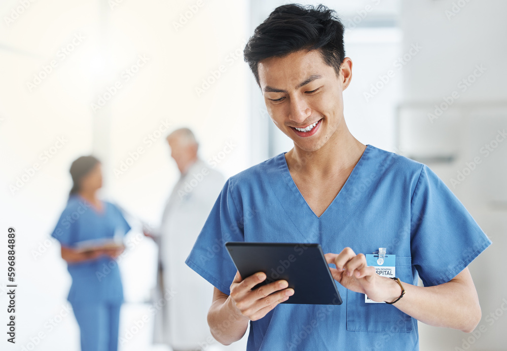 Getting loads more done in digital format. Shot of a young doctor using a digital tablet in a hospital. - obrazy, fototapety, plakaty 