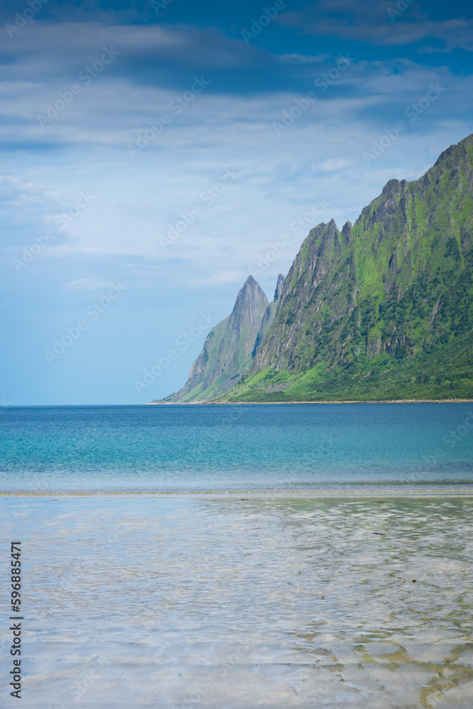 The crystal clear water of the Ersfjordstranda beach in Senja Island,  Norway