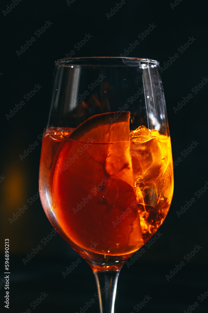 cocktail on a dark background with ice and fruits. menu format
cocktail on a dark background with ice and fruits. menu format