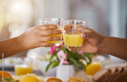 Starting our day off right. Shot of an unrecognizable couple toasting while having lunch at home.