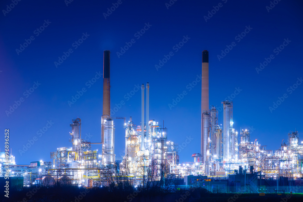 View of the plant at night. Industrial landscape. Production. Heavy industry. Processing of oil and gas.  Industrial area in the evening.