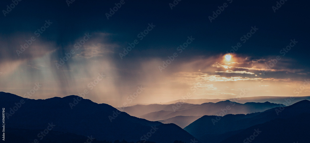 banner of mountain peaks in beautiful stormy sunset light