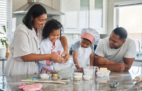 Love is a key ingredient. Shot of a couple baking at home with their two children.