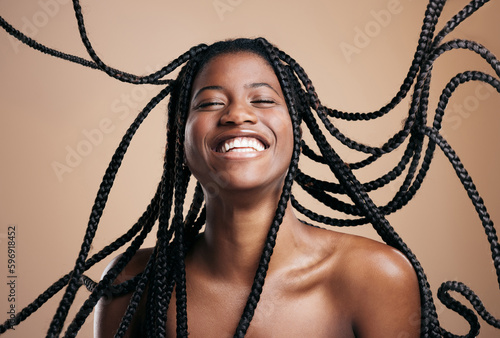 Sometimes youve just gotta let loose. Cropped shot of an attractive young woman posing in studio against a brown background. photo