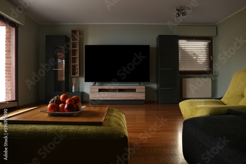 Stylish room with beautiful furniture and TV set on table. Interior design