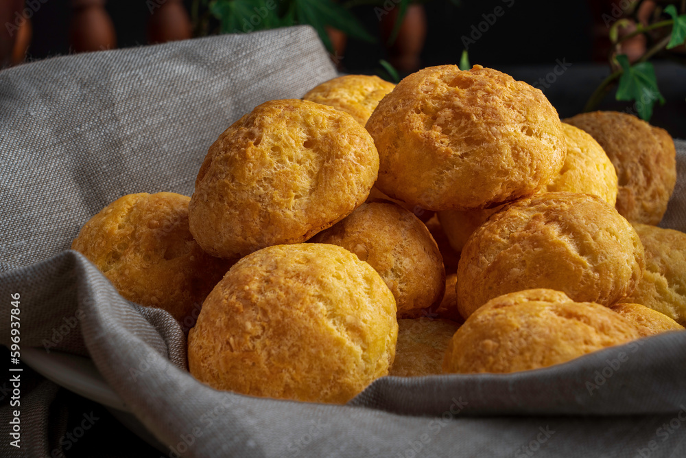 French cheese puffs made from savory choux pastry with cheddar and parmesan cheese, then baked until golden brown. French cheese puffs made from savory choux pastry with cheddar and parmesan cheese, then baked until golden brown.