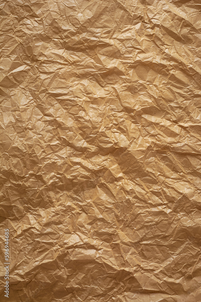Fototapeta premium crumpled thin brown paper, brownish tone wrinkled recycle sheet of paper surface background texture, graphic resources with space for text