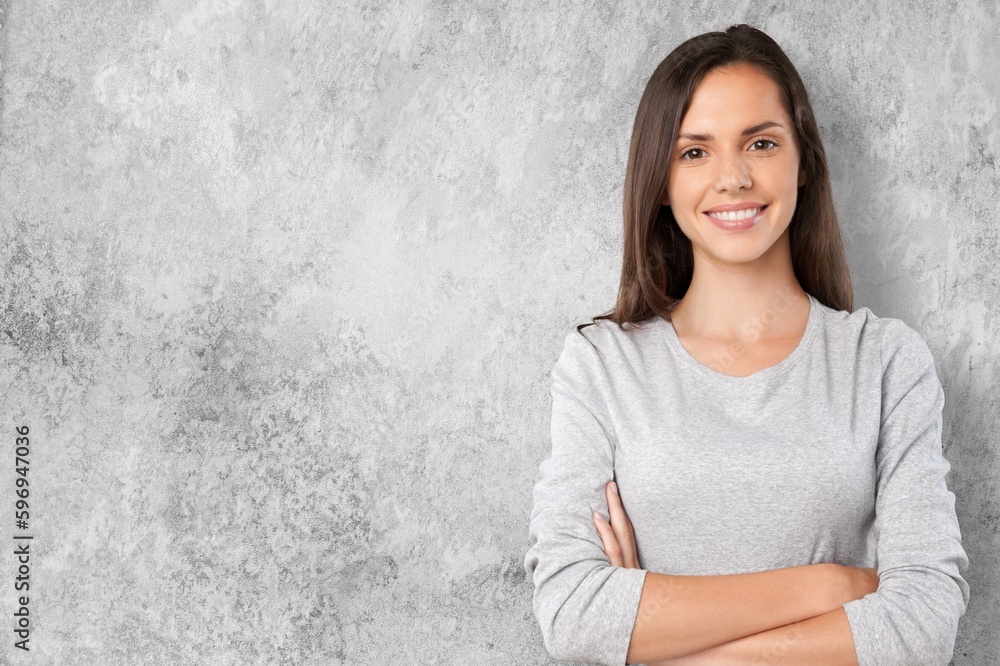 Portrait of young woman posing on wall background Portrait of young woman posing on wall background
