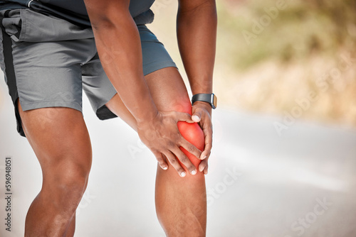 No pain , no gain. Cropped shot of an unrecognizable man standing alone outside and suffering from a knee injury during his run.