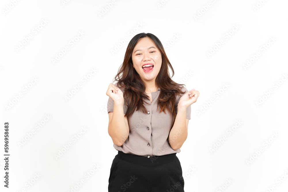 Asian woman ecstatically raises her hands in triumph, exclaiming 'yes!' against a white background Asian woman ecstatically raises her hands in triumph, exclaiming 'yes!' against a white background