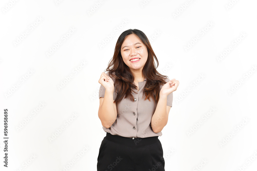 Asian woman ecstatically raises her hands in triumph, exclaiming 'yes!' against a white background Asian woman ecstatically raises her hands in triumph, exclaiming 'yes!' against a white background