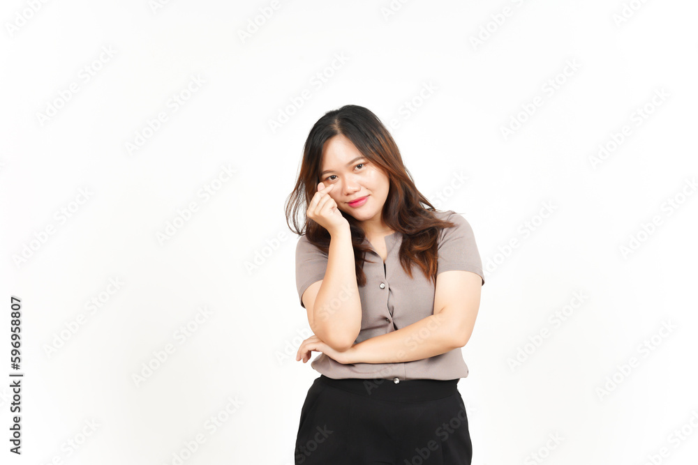 An Asian woman is showing the Korean love sign with a white background, smiling brightly An Asian woman is showing the Korean love sign with a white background, smiling brightly